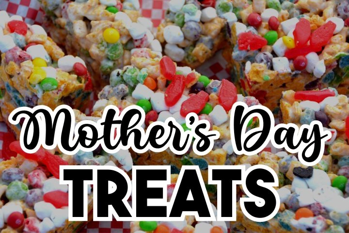 A beautifully arranged tray of Mother's Day treats including cupcakes, cookies, and fresh berries, perfect for a special celebration.