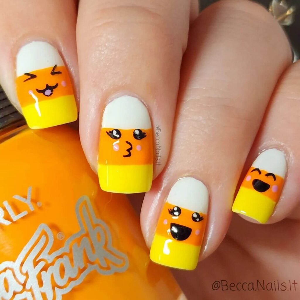 Close-up of candy corn nails with vibrant yellow, orange, and white stripes, perfect for Halloween.