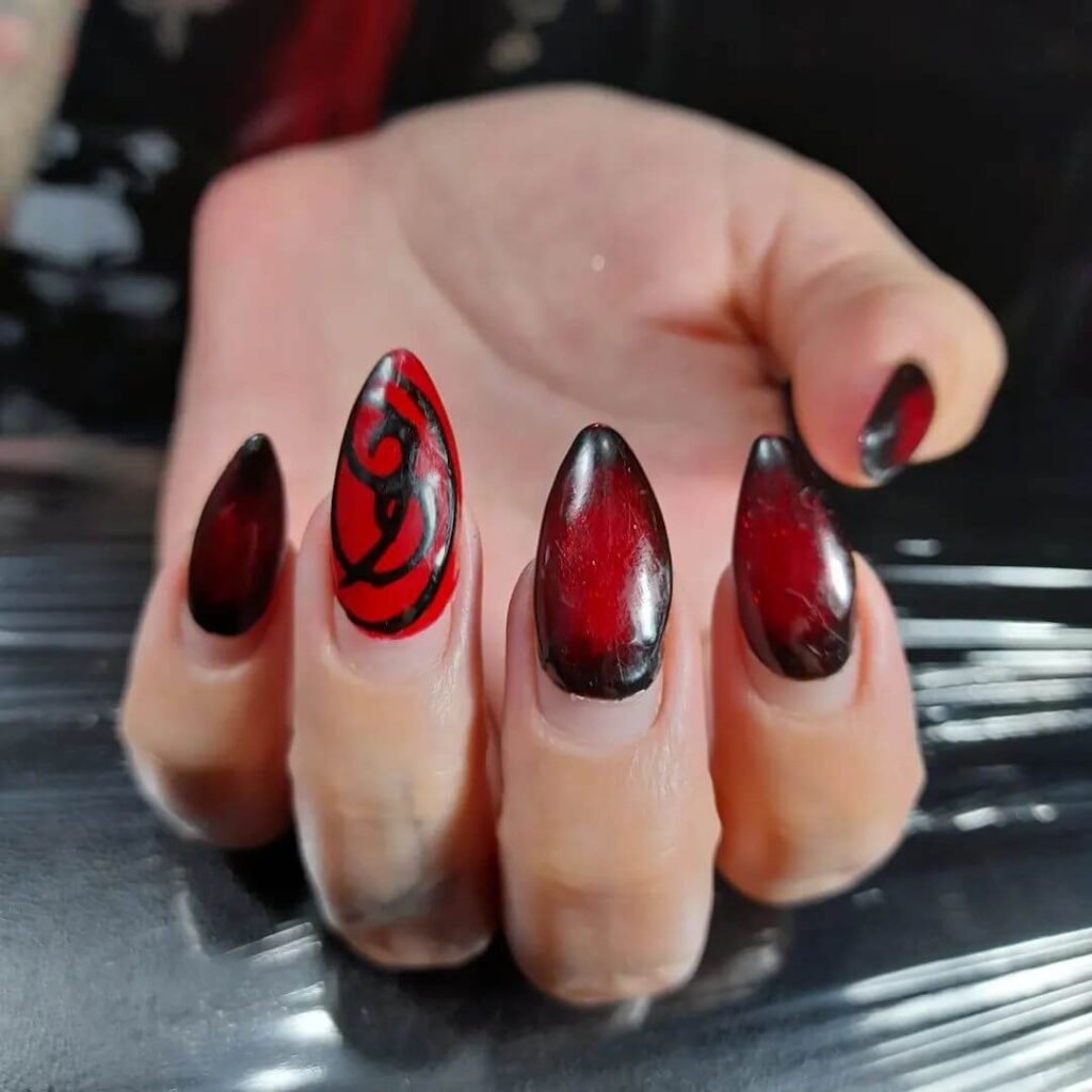 beautifully designed dark nails featuring black and burgundy fall nail designs with a glossy finish.