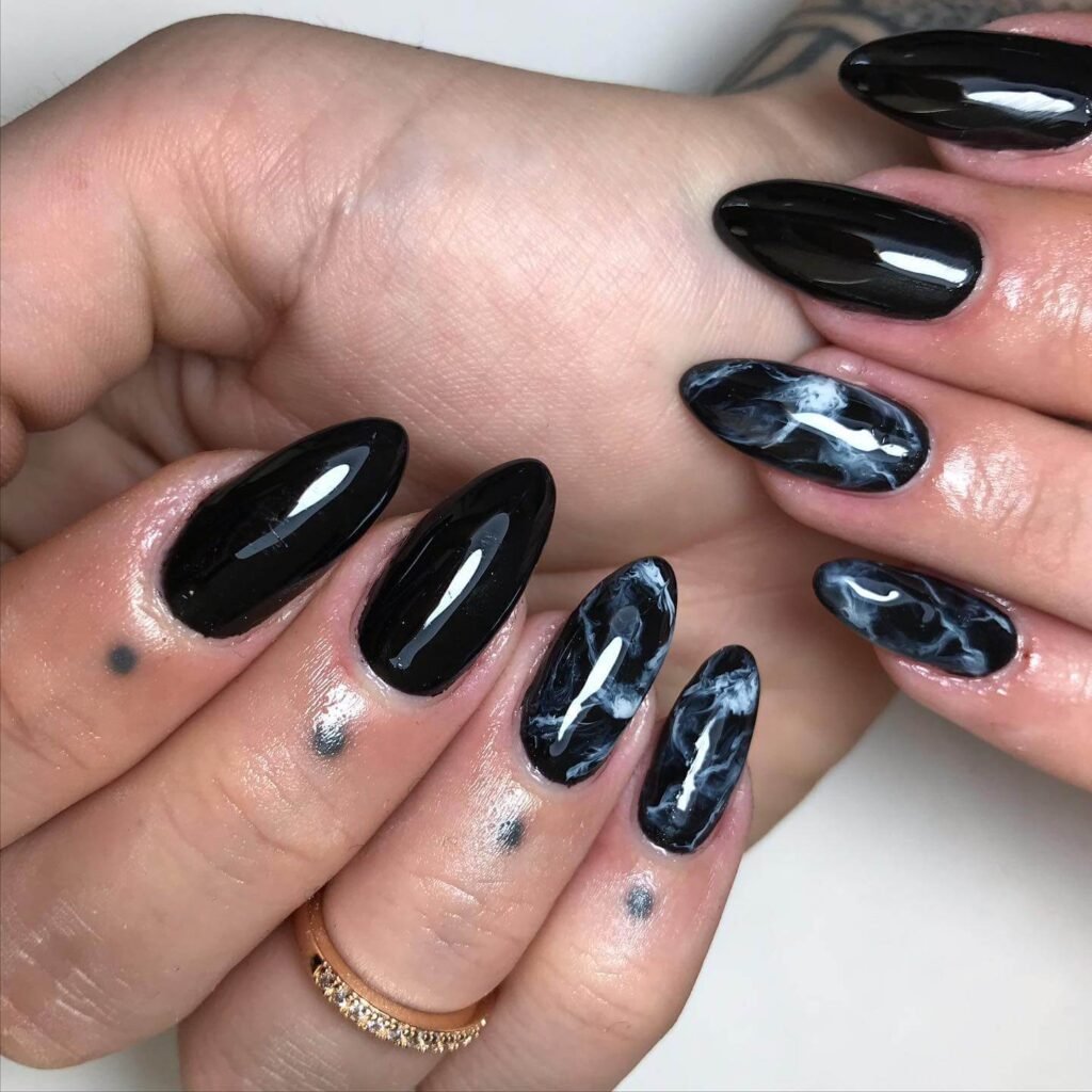 beautifully designed dark nails featuring black and burgundy fall nail designs with a glossy finish.