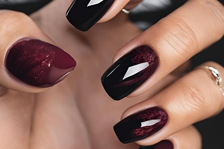 beautifully designed dark nails featuring black and burgundy fall nail designs with a glossy finish.