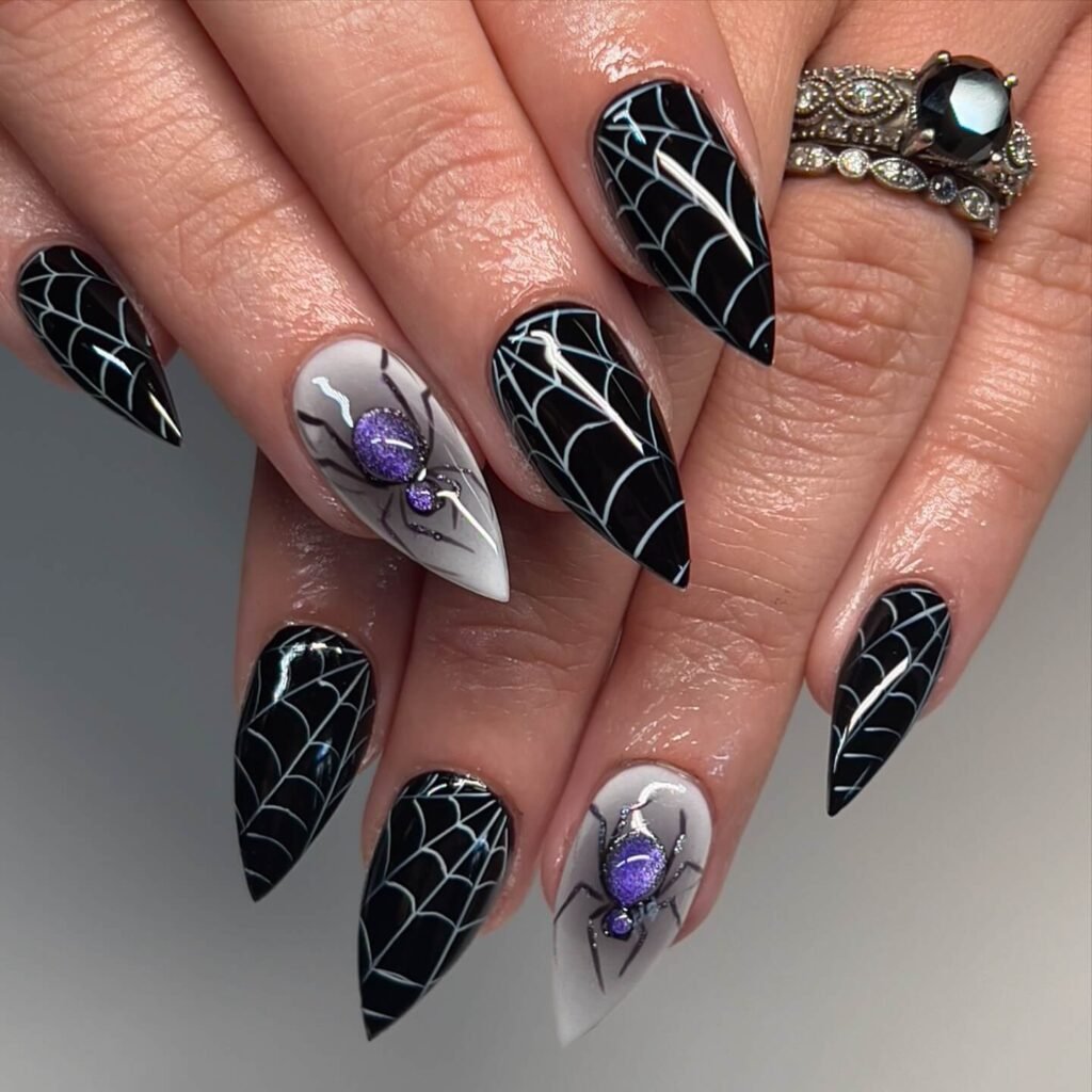 A set of spooky Halloween acrylic nails with designs like bats, ghosts, and pumpkins, ideal for October.