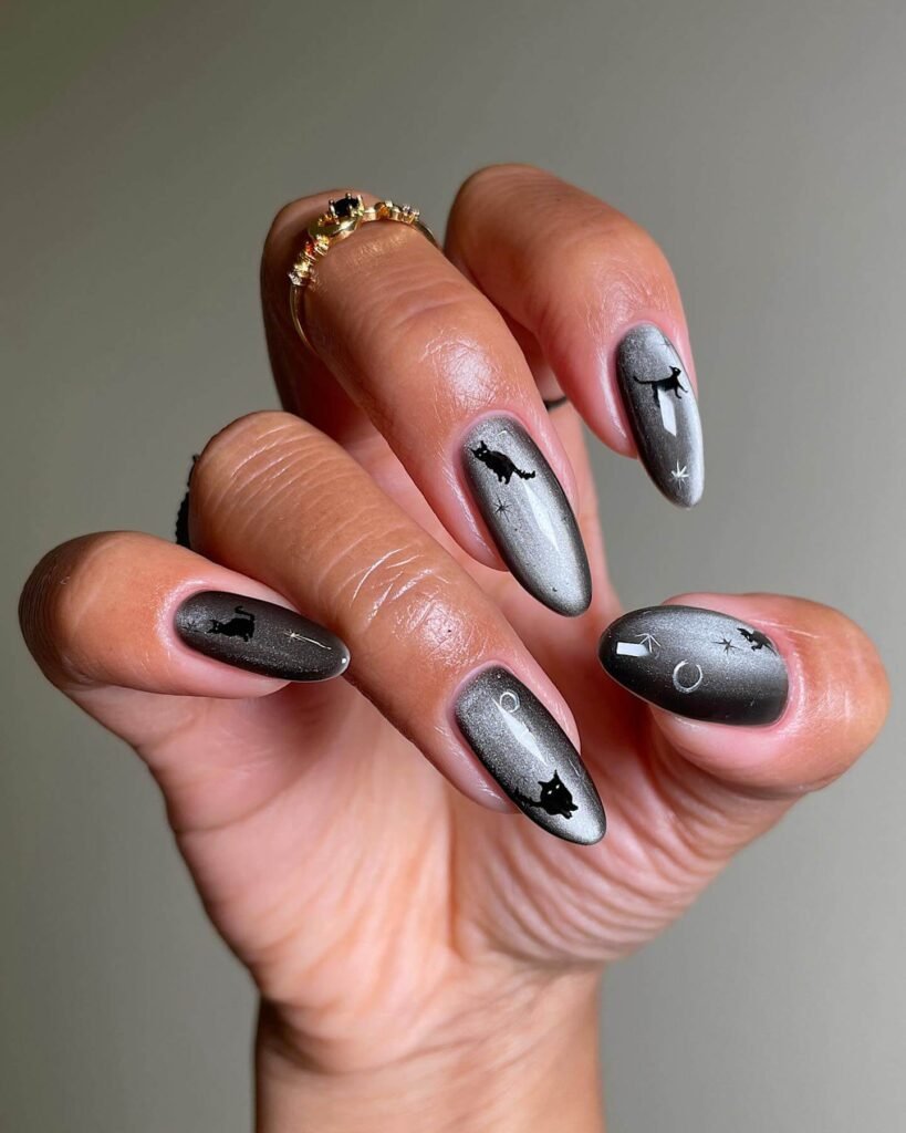 A set of spooky Halloween acrylic nails with designs like bats, ghosts, and pumpkins, ideal for October.