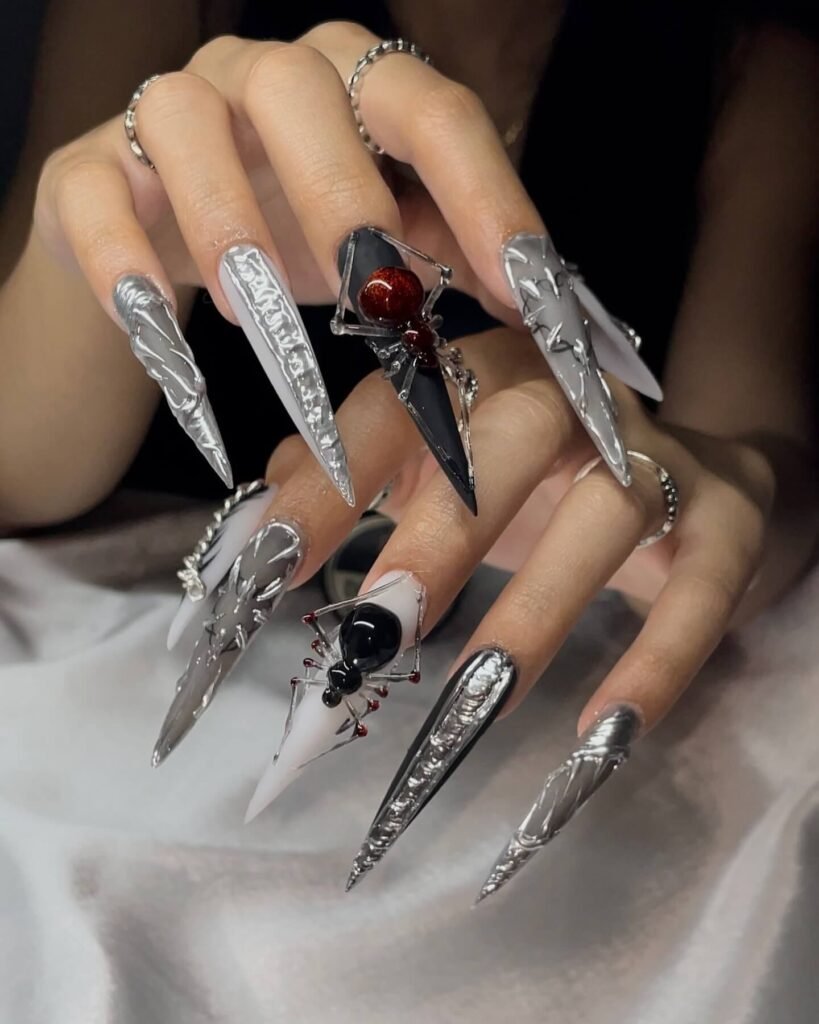 A set of spooky Halloween acrylic nails with designs like bats, ghosts, and pumpkins, ideal for October.