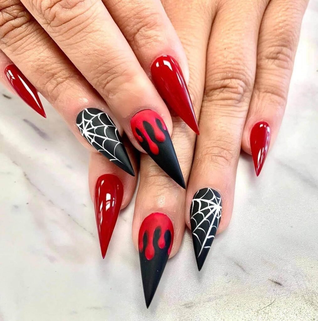 A set of spooky Halloween acrylic nails with designs like bats, ghosts, and pumpkins, ideal for October.