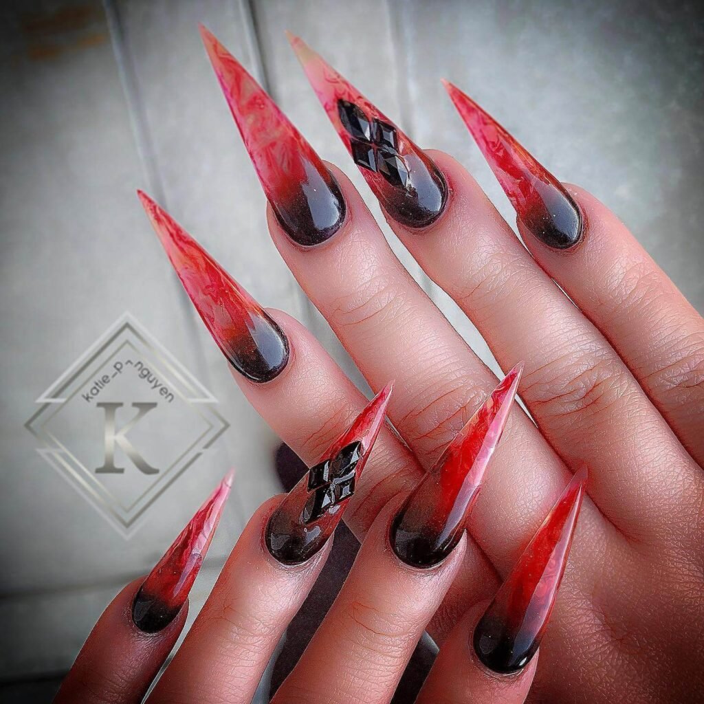 A set of spooky Halloween acrylic nails with designs like bats, ghosts, and pumpkins, ideal for October.