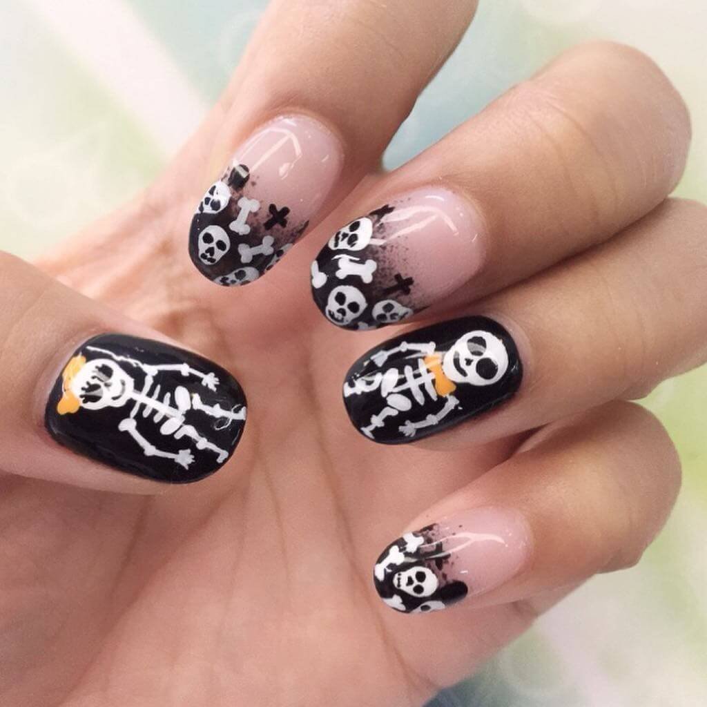 A set of spooky Halloween acrylic nails with designs like bats, ghosts, and pumpkins, ideal for October.